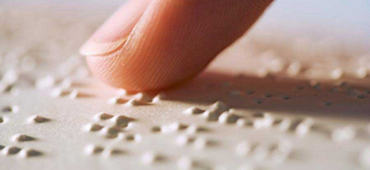 What is Braille and how is it used on signs in Australia?